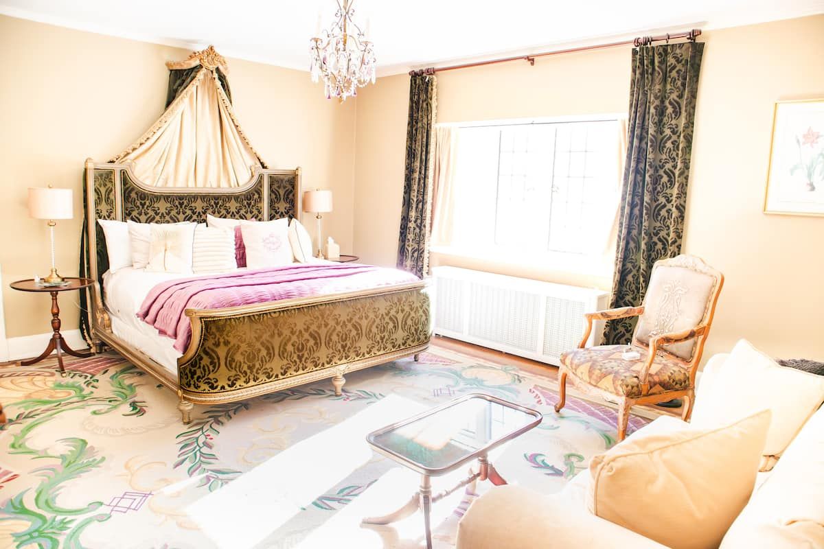 Rose Room — ornate canopy king bed with crystal chandelier