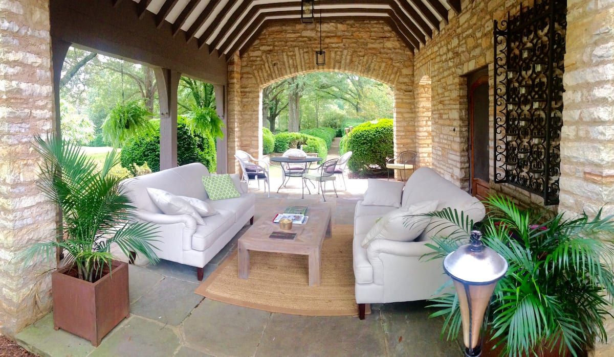 Covered stone loggia with outdoor living room