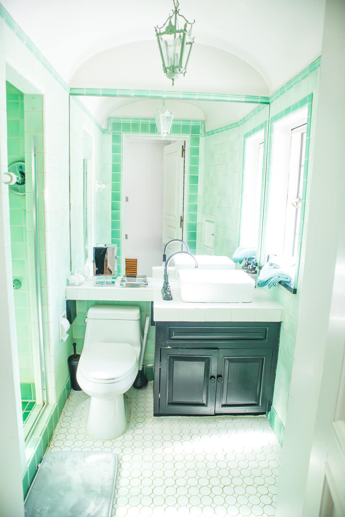 Elegant powder room with ornate mirror and faux-finish walls