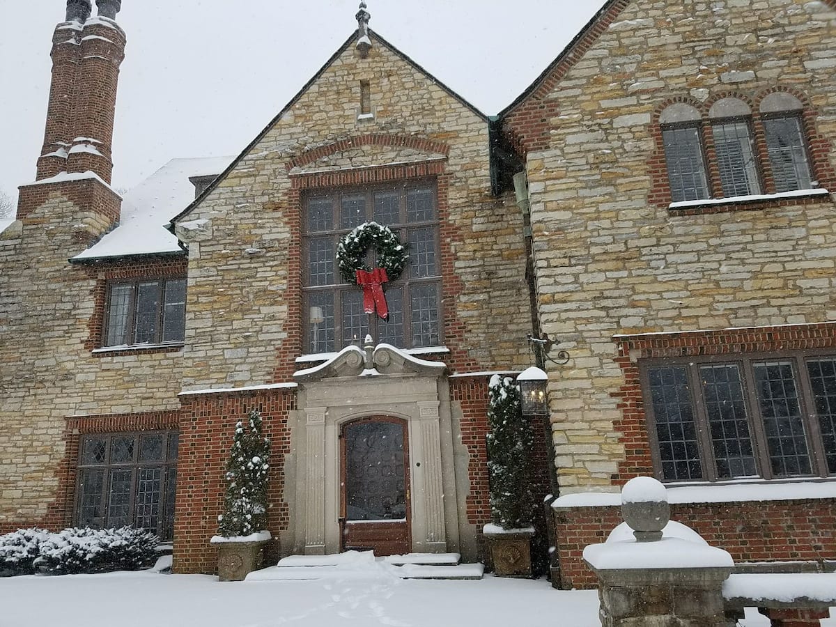 Mansion entrance in snow with Christmas wreath