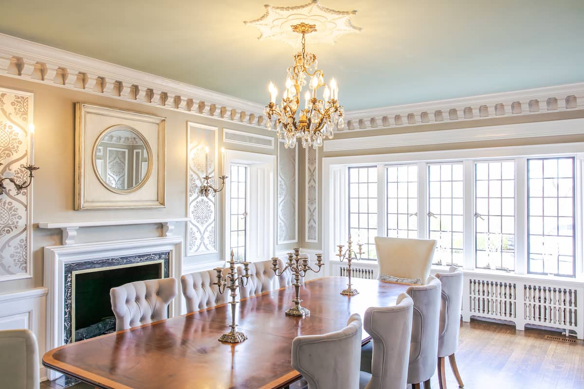 Formal dining room with long table and crystal chandelier