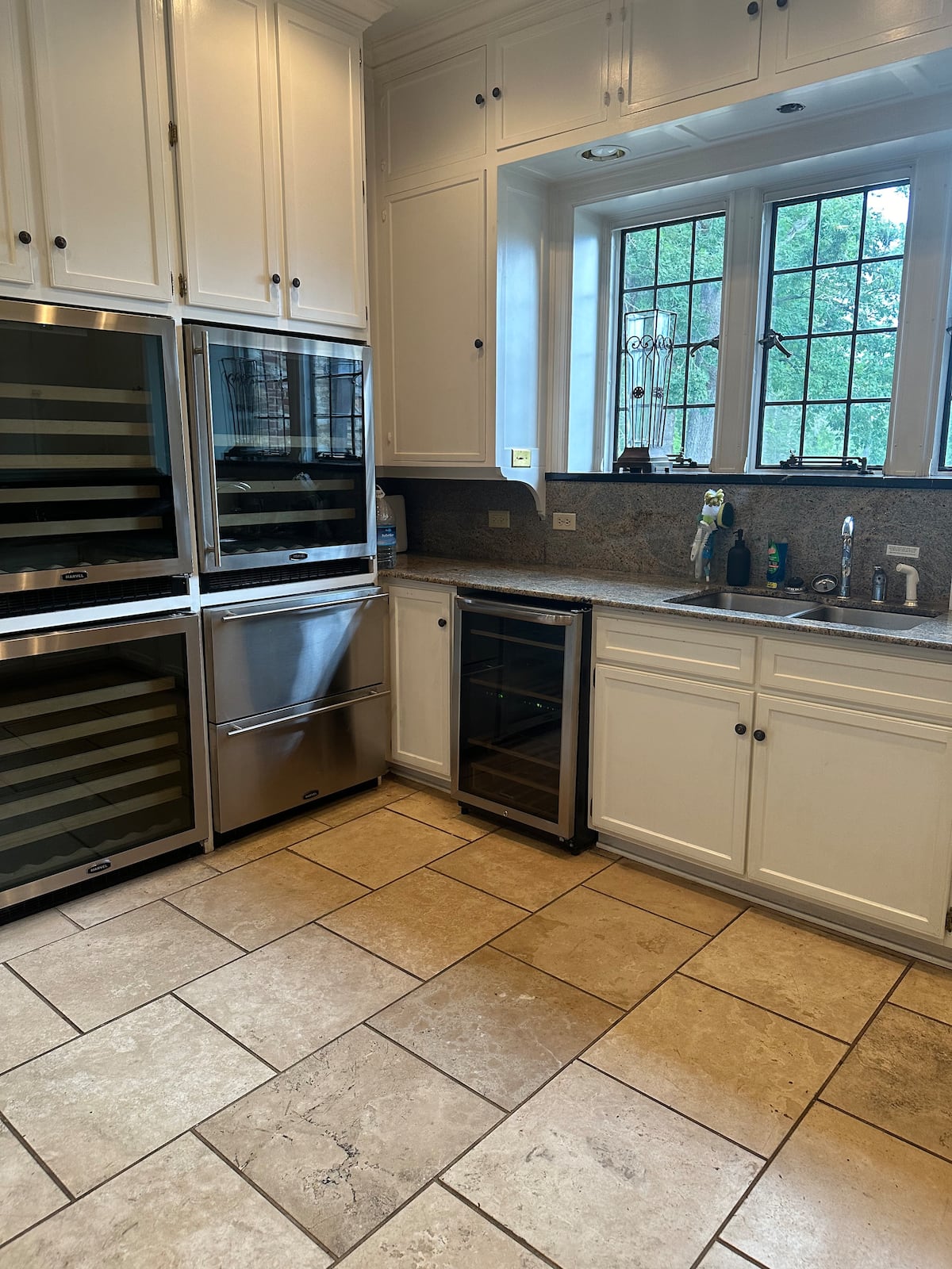 Kitchen with wine fridges and white cabinetry