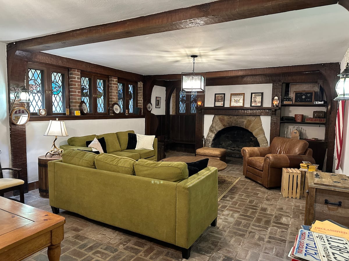 Rustic lounge with stone fireplace and stained glass windows