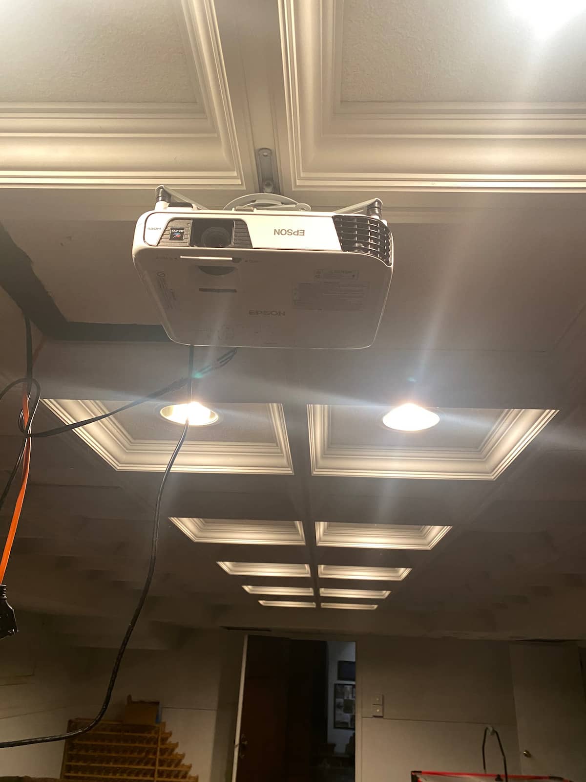 Ceiling-mounted projector in coffered ceiling theater room