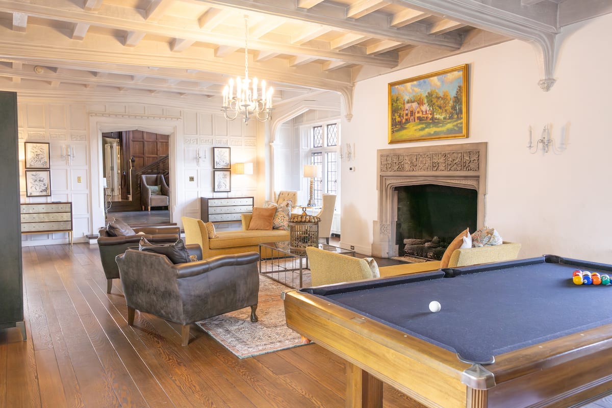 Great room with pool table and stone fireplace